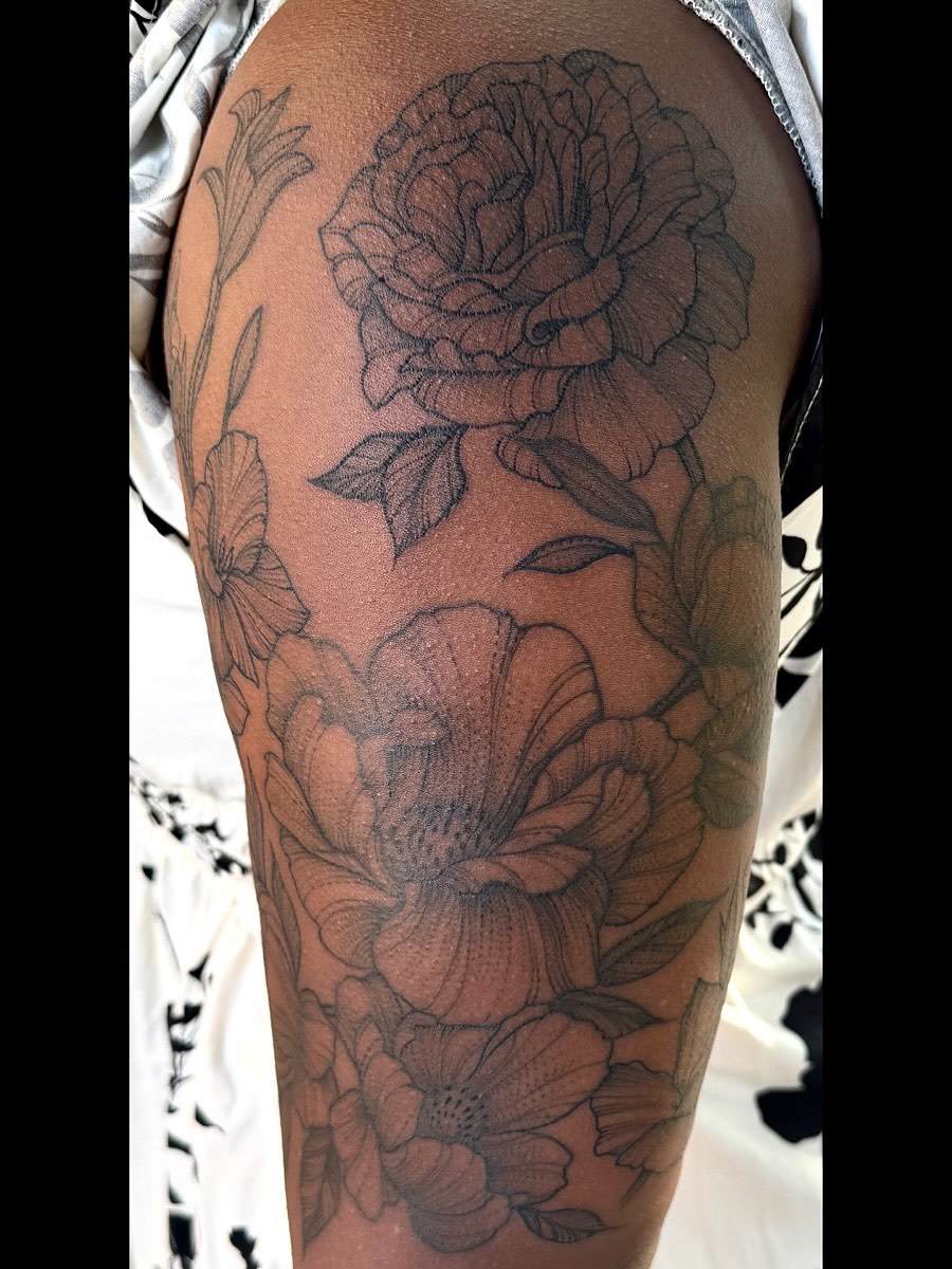 Floral arrangement black and grey tattoo on the forearm by Jacob Kearney