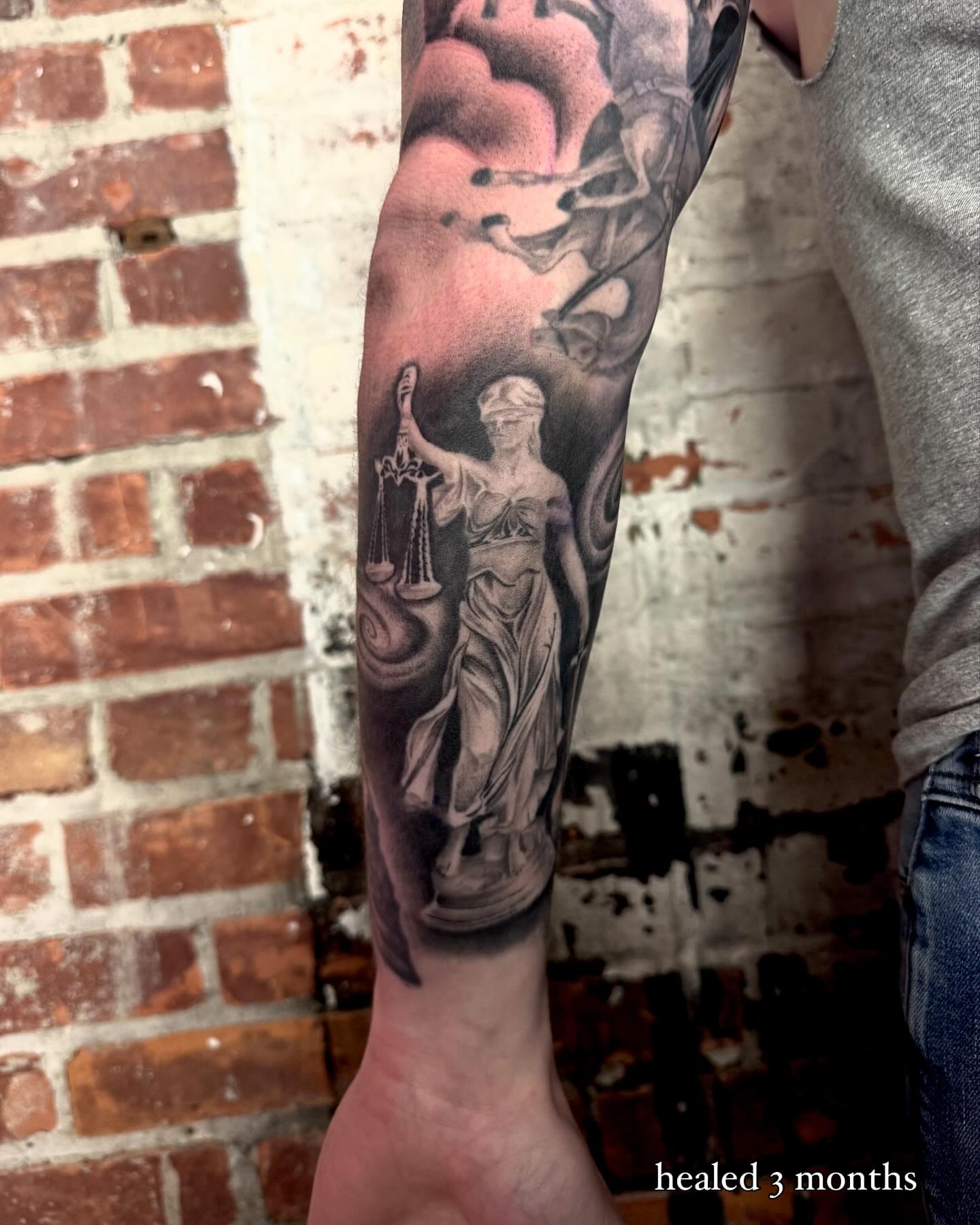 Statue of justice realism tattoo on the forearm by Isabel Smith🦋🕷️