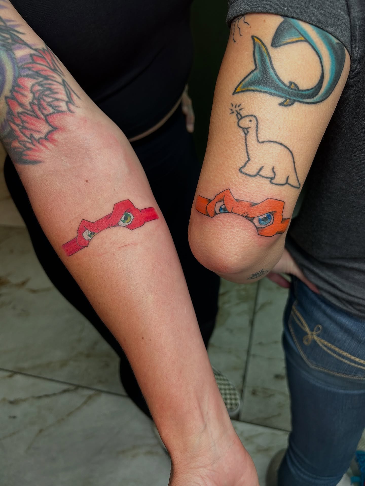 Red mask American traditional tattoo on the forearm by Melissa C, Phoenix, Arizona