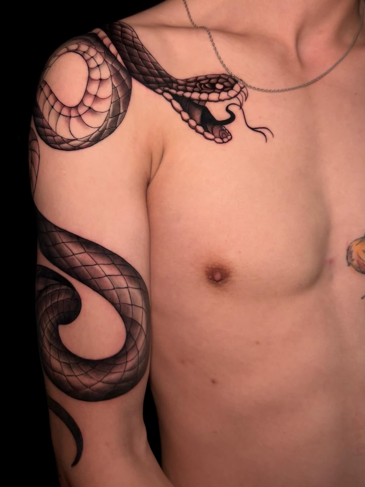 Snake black and grey tattoo on the chest by Chloe