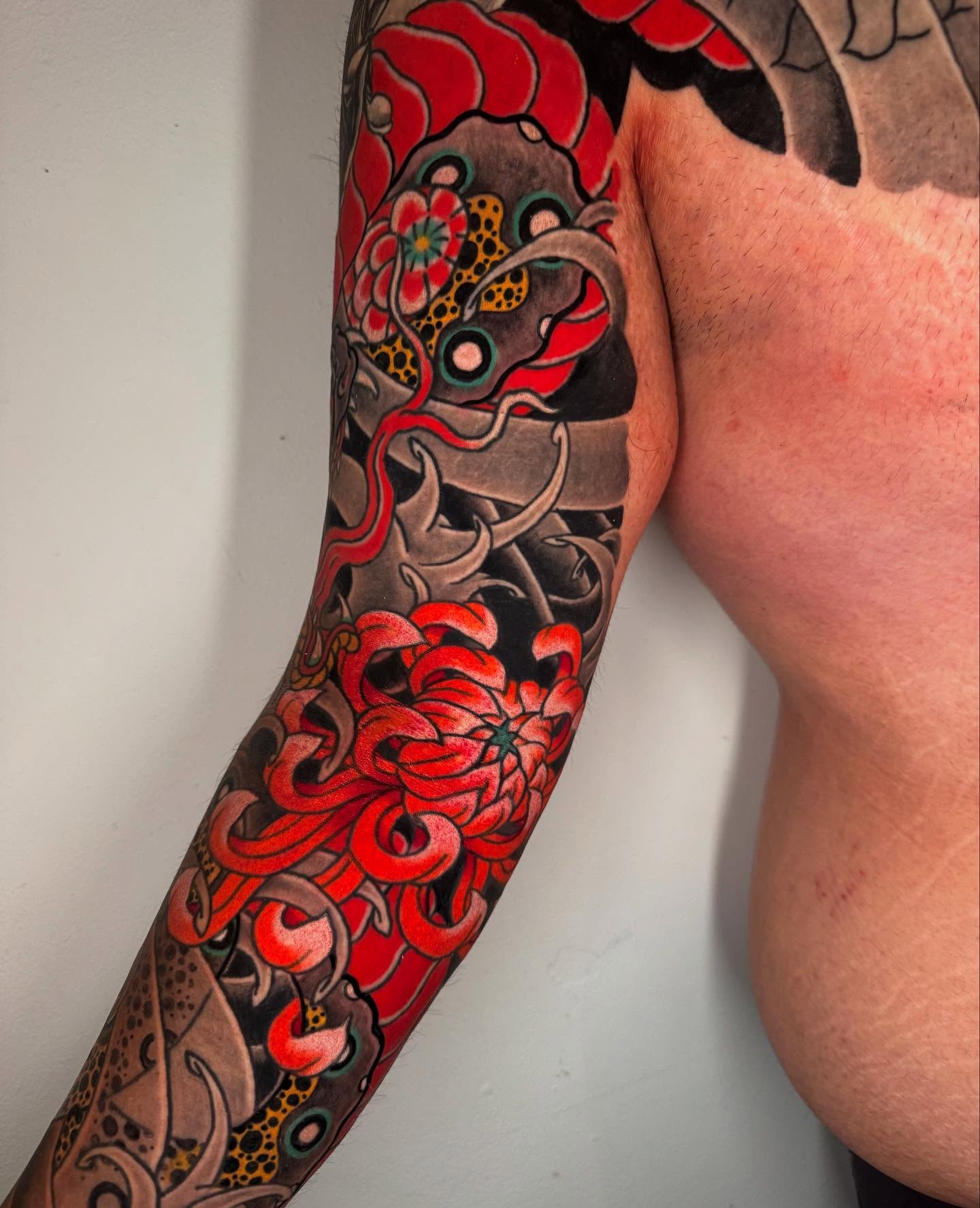 Chrysanthemum and dragon japanese irezumi tattoo on the forearm by Mr Nikita, New York, New York