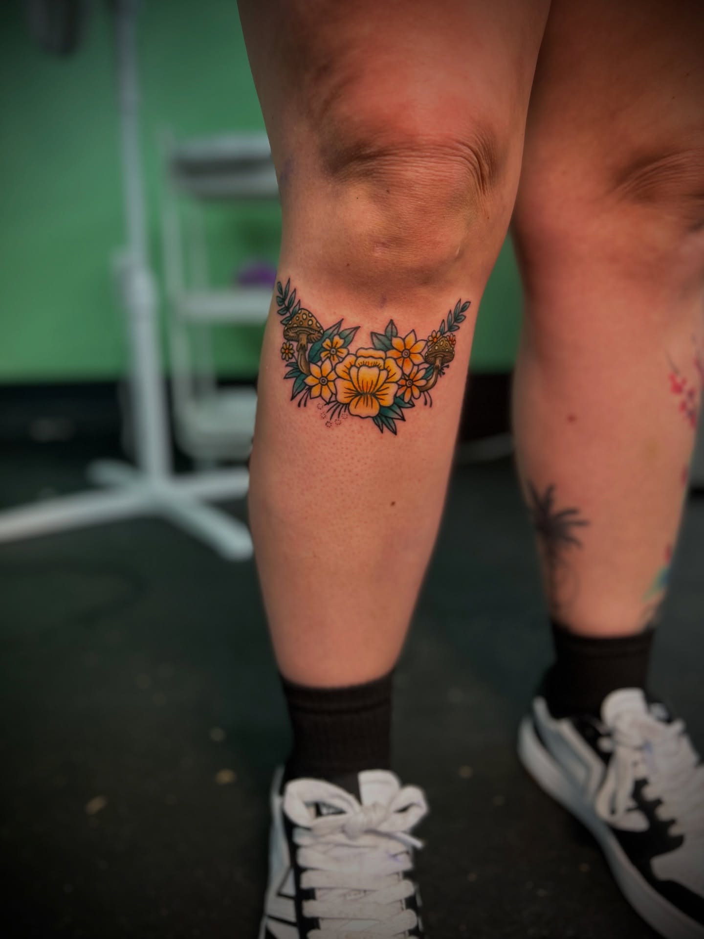 Floral wreath new school tattoo on the calf by Kiersten Tickle