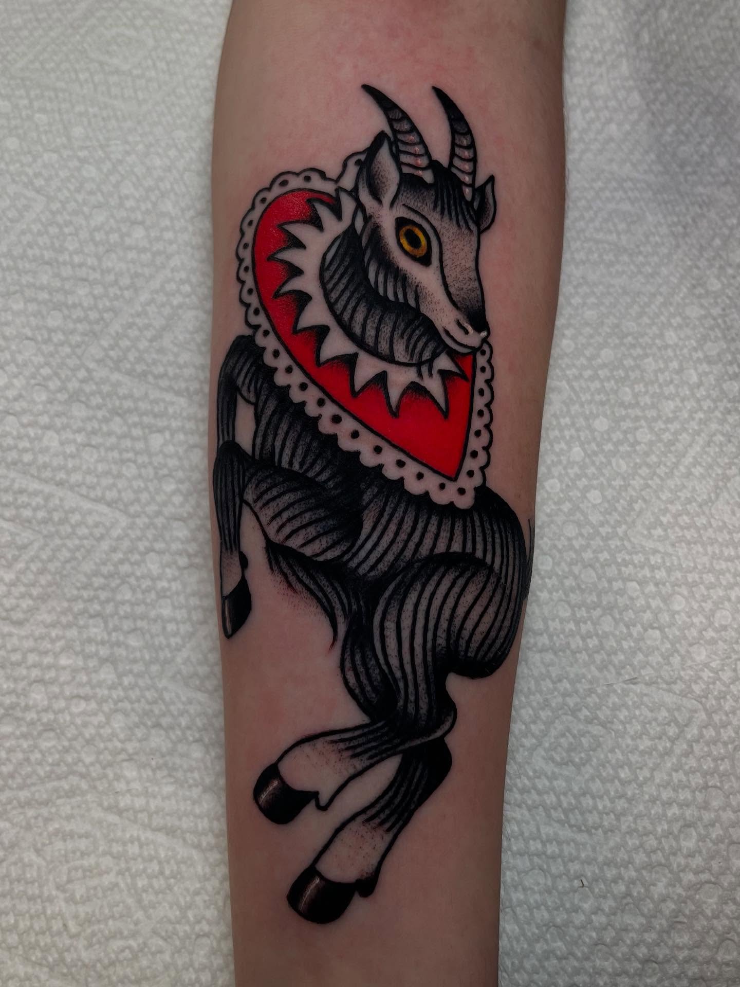 Goat with heart American traditional tattoo on the forearm by Marqui Watling