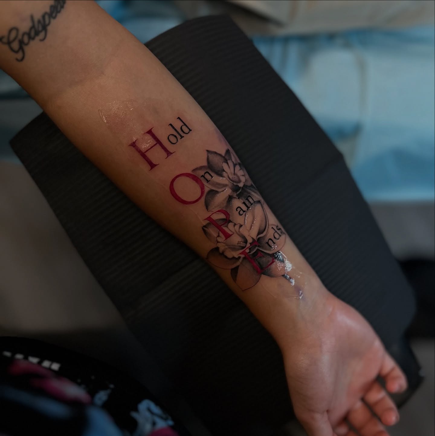 Flower and text dotwork tattoo on the forearm by mssinderella