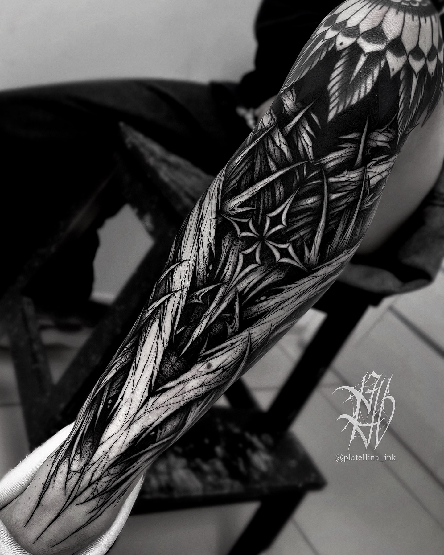 Abstract floral pattern geometric tattoo on the forearm by Dark Gothic Tattoo
