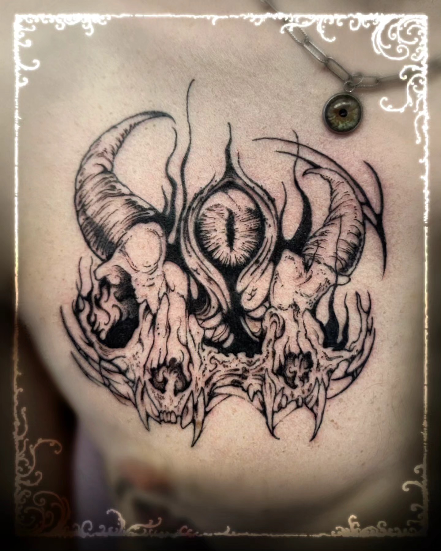 Demon skulls dark realism tattoo on the chest by Luca