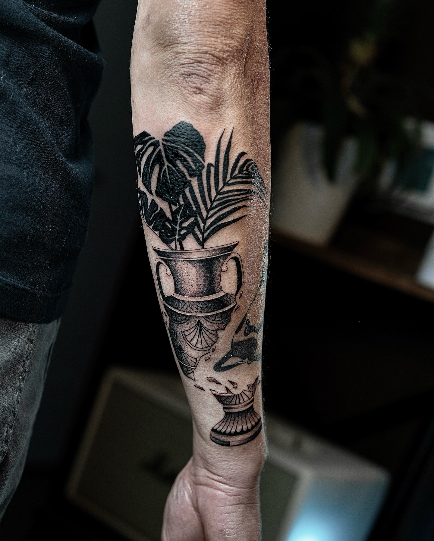 Plant pot and leaves black and grey tattoo on the forearm by Fine line tattoo San Diego, San Diego, California