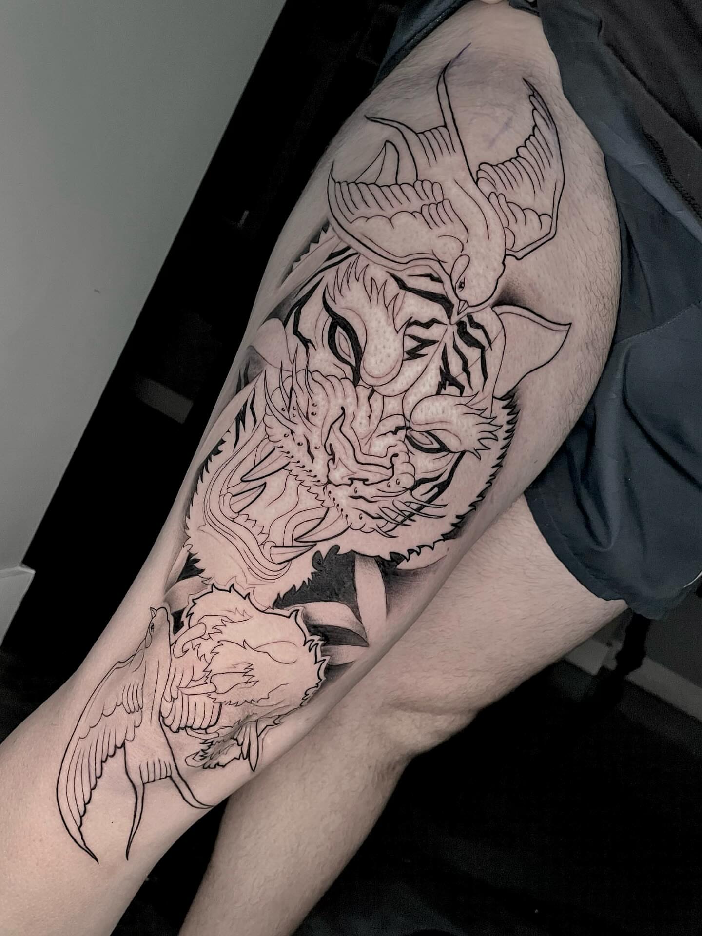 Dragon and bird black and grey tattoo on the thigh by Xena