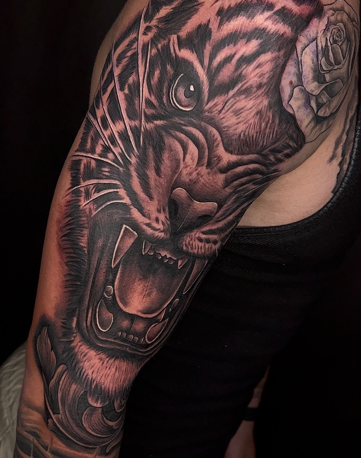 Tiger realism tattoo on the upper arm by Elijah East
