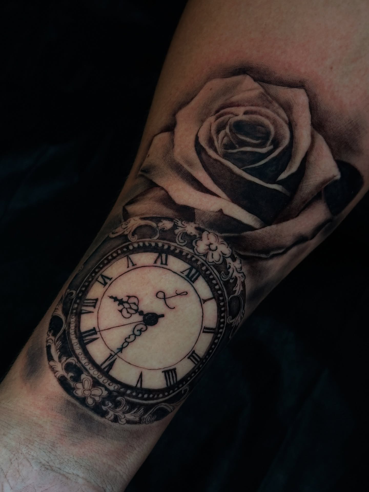 Clock and rose realism tattoo on the forearm by Dennis Alejandro