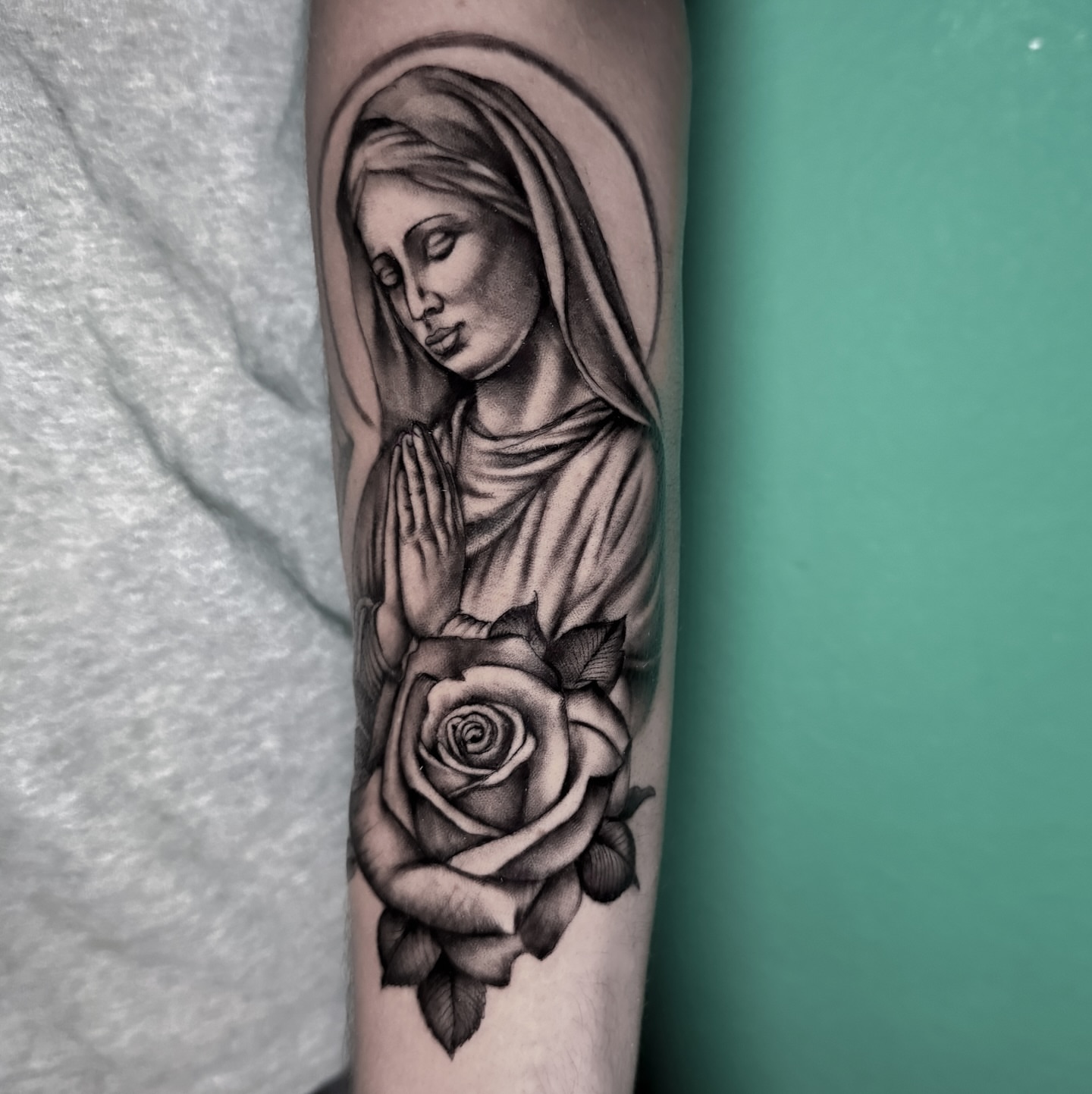 Praying woman with roses realism tattoo on the forearm by @sadfoo_tattoo, Austin, Texas