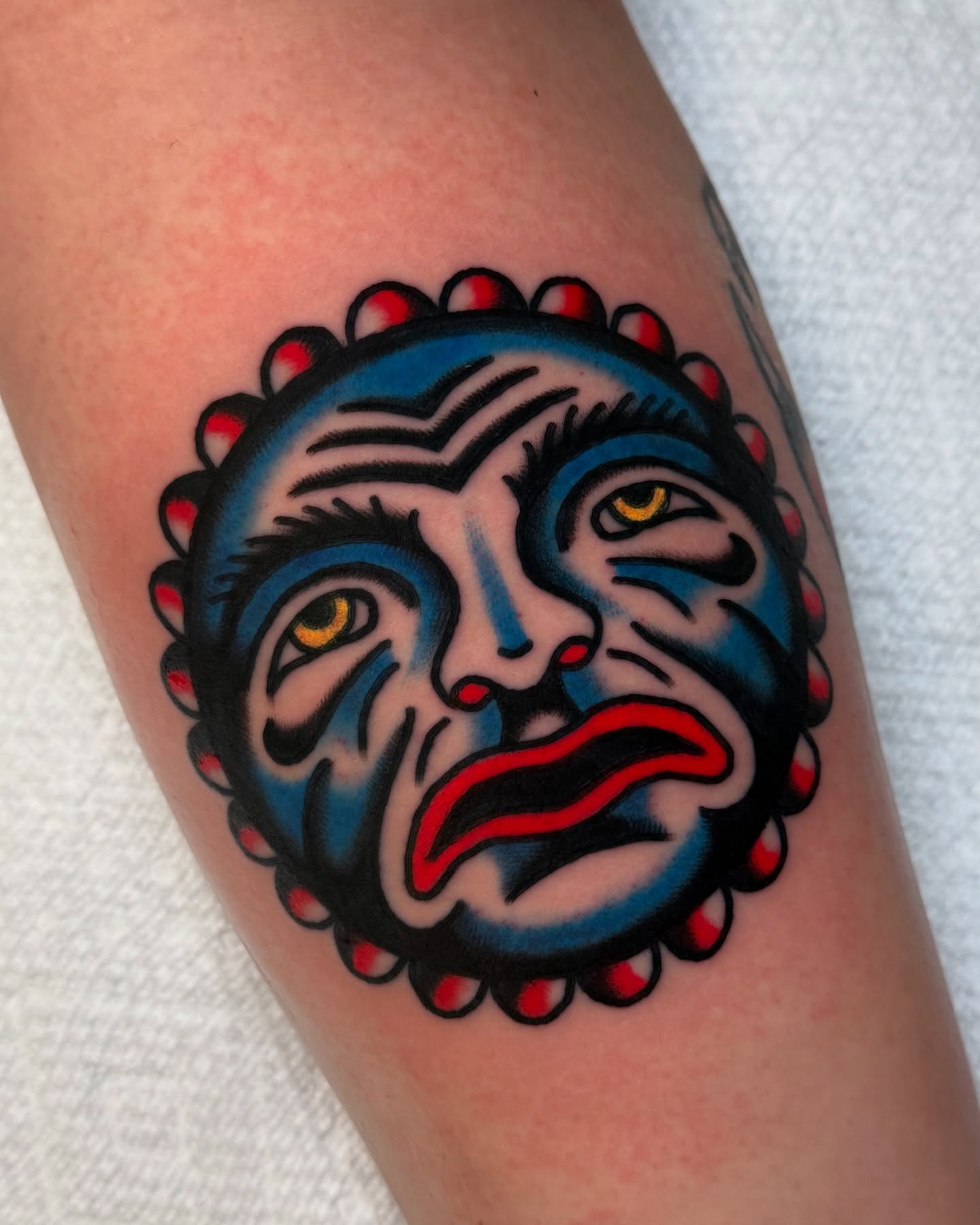 Sad clown mask American traditional tattoo on the forearm by Zachary - Traditional Tattoo Artist