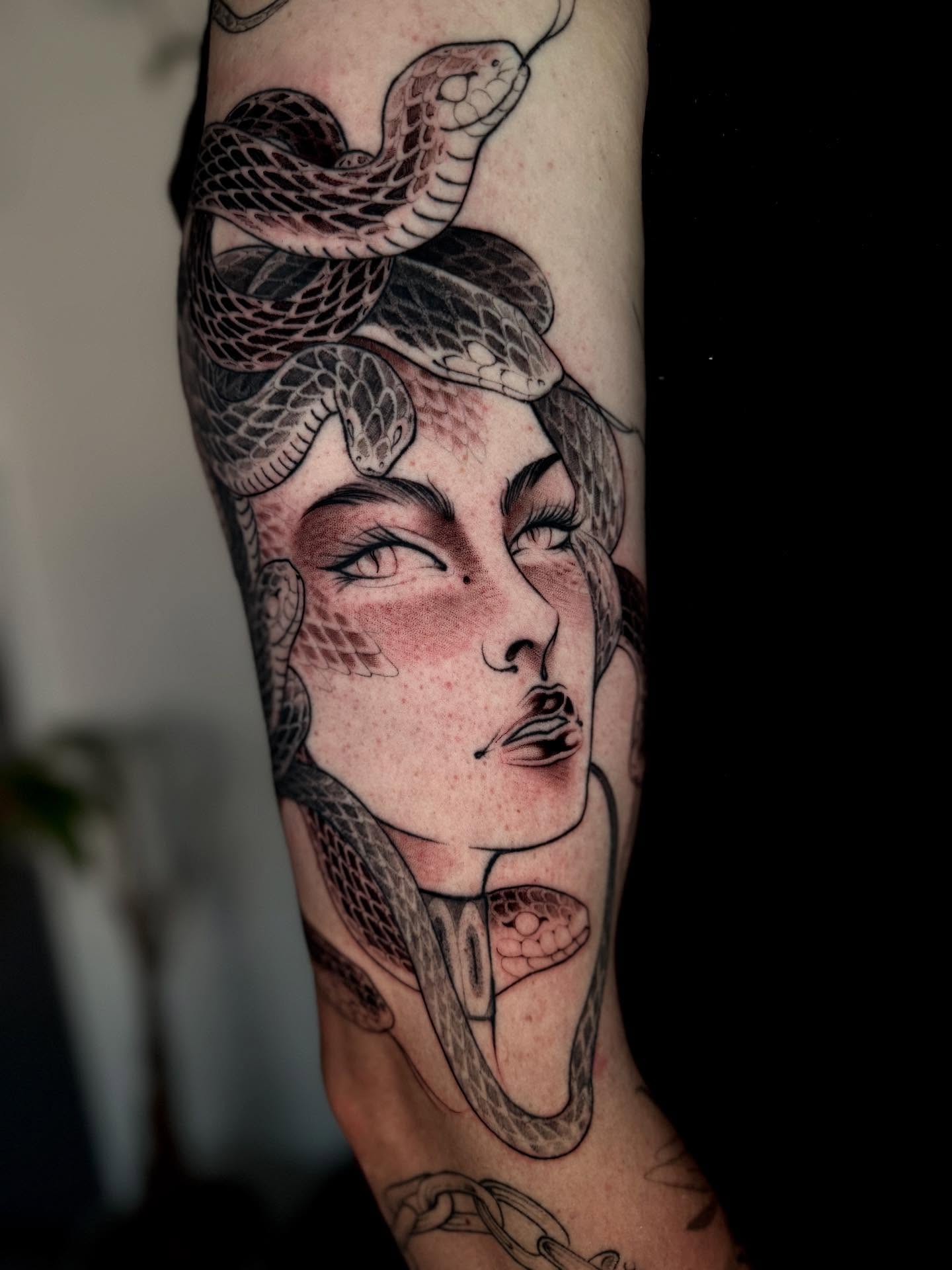 Woman with snake realism tattoo on the forearm by Angelo Buonanno, Las Vegas, Nevada