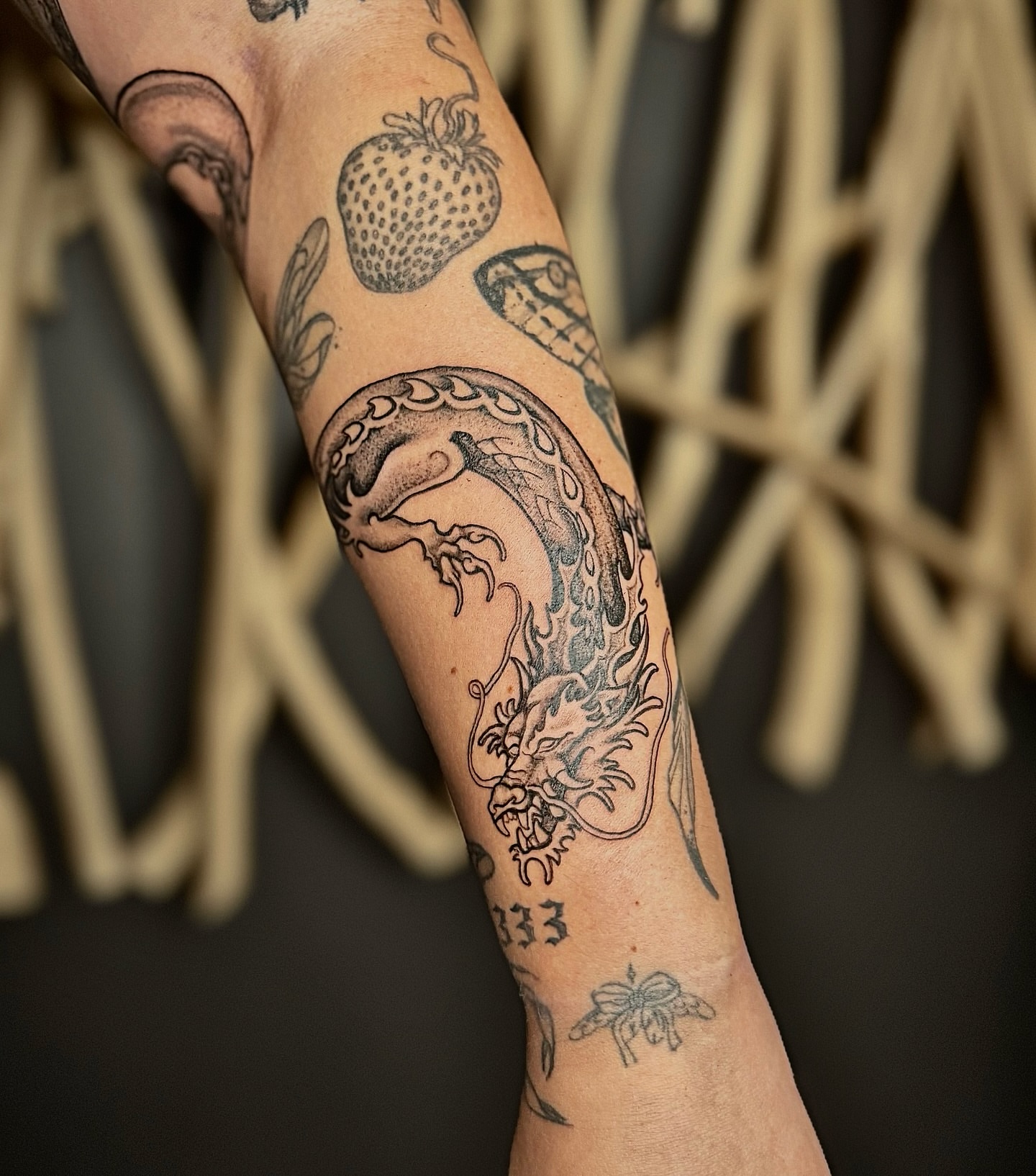 Dragon black and grey tattoo on the forearm by Jewels, St. George, Utah
