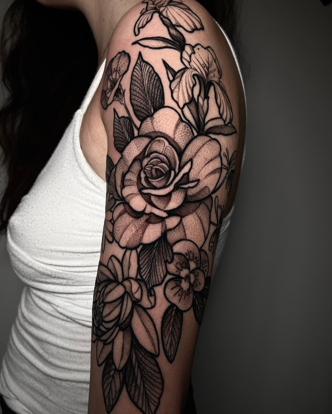 Floral bouquet realism tattoo on the upper arm by H A N N A H, Colorado Springs, Colorado