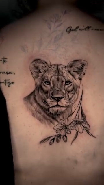 Lioness portrait with flowers realism tattoo by Tiago Britto