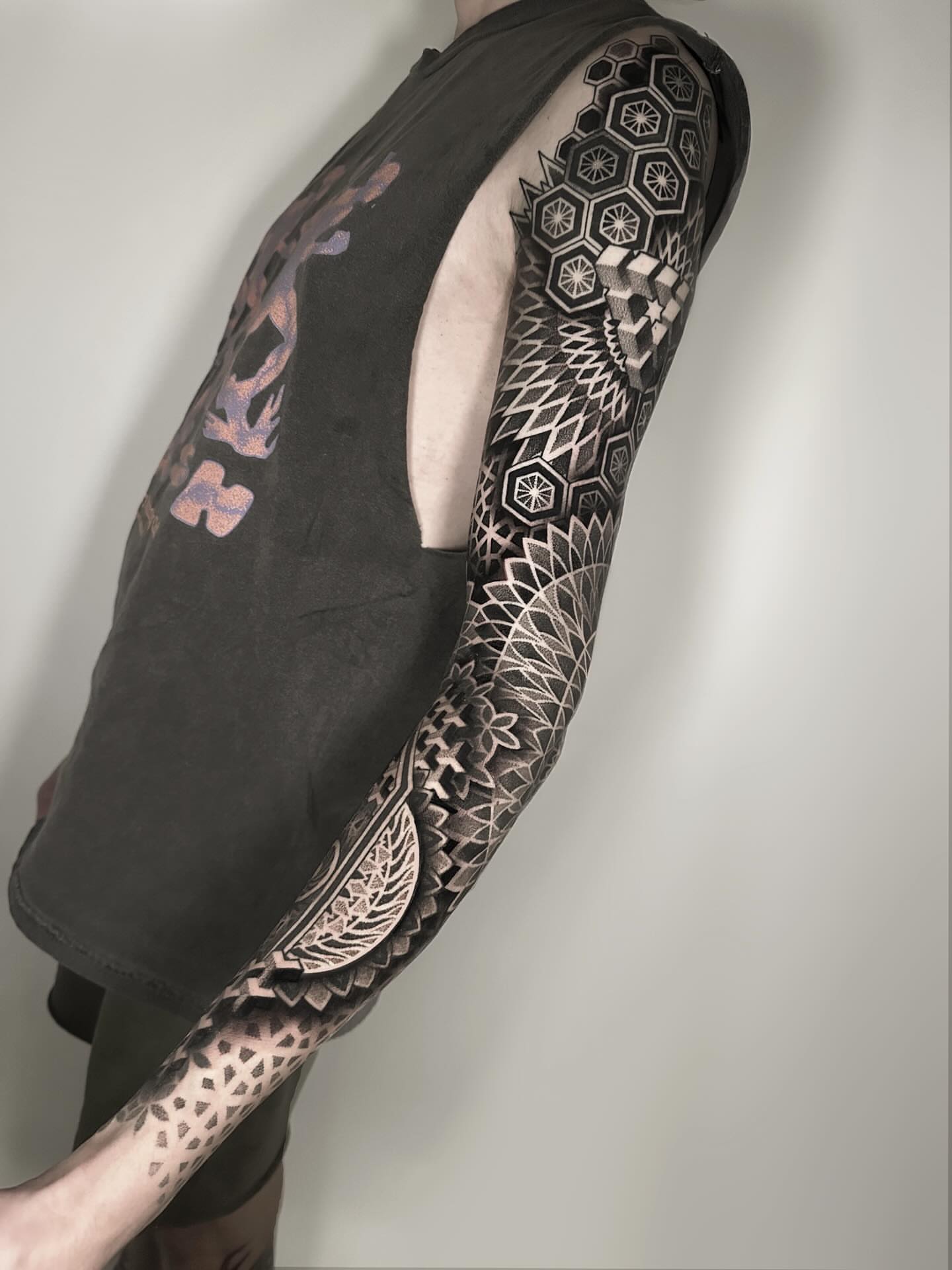 Geometric patterns geometric tattoo on the upper arm by Kevin Johnson