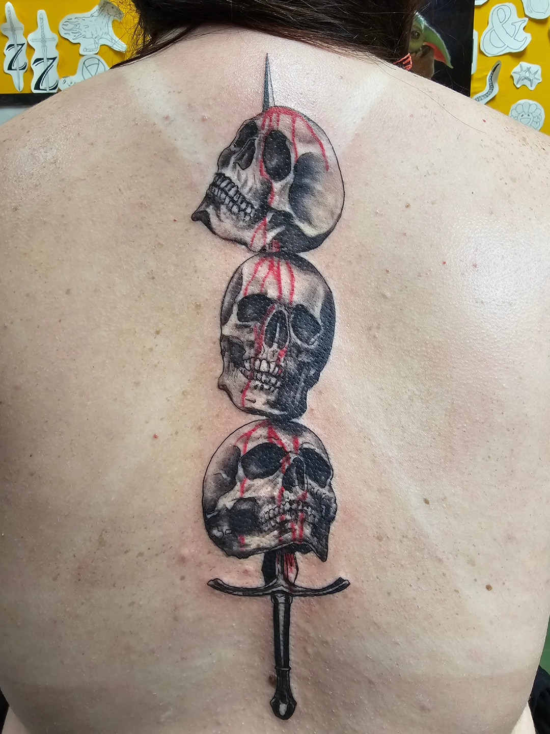 Skulls and dagger realism tattoo on the back by Mike Stamper