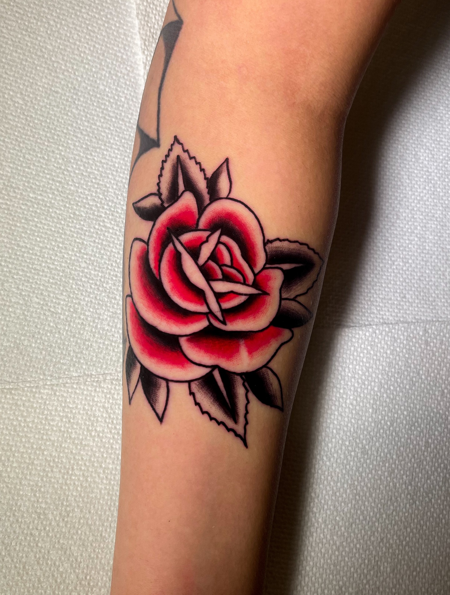 Rose American traditional tattoo on the forearm by Miguel Henrik