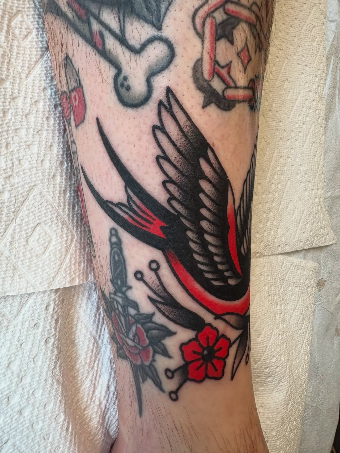 Swallow and flowers American traditional tattoo on the forearm by Seattle Tattoo Artist, Bonney Lake, Washington