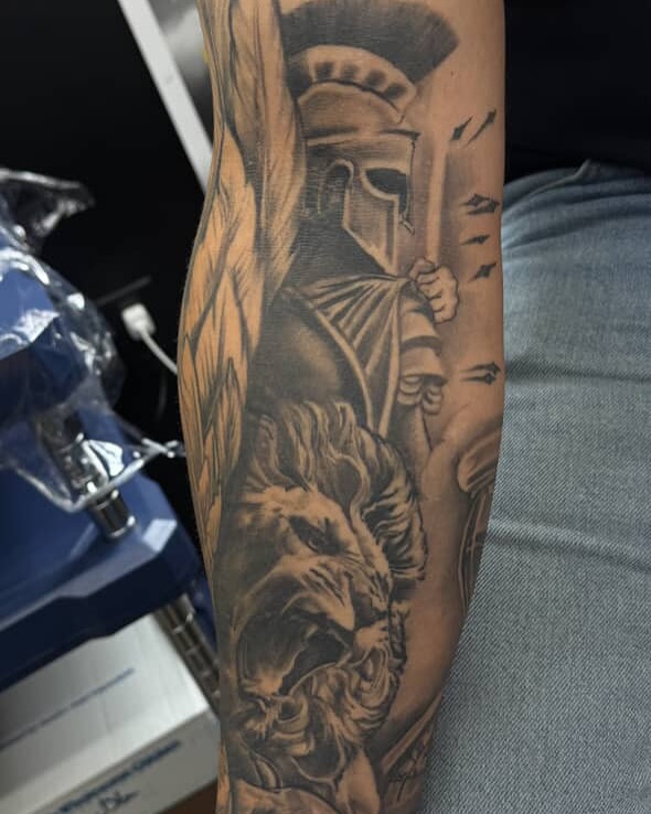 Lion and warrior realism tattoo on the forearm by Lu Ve, Dayton, Ohio