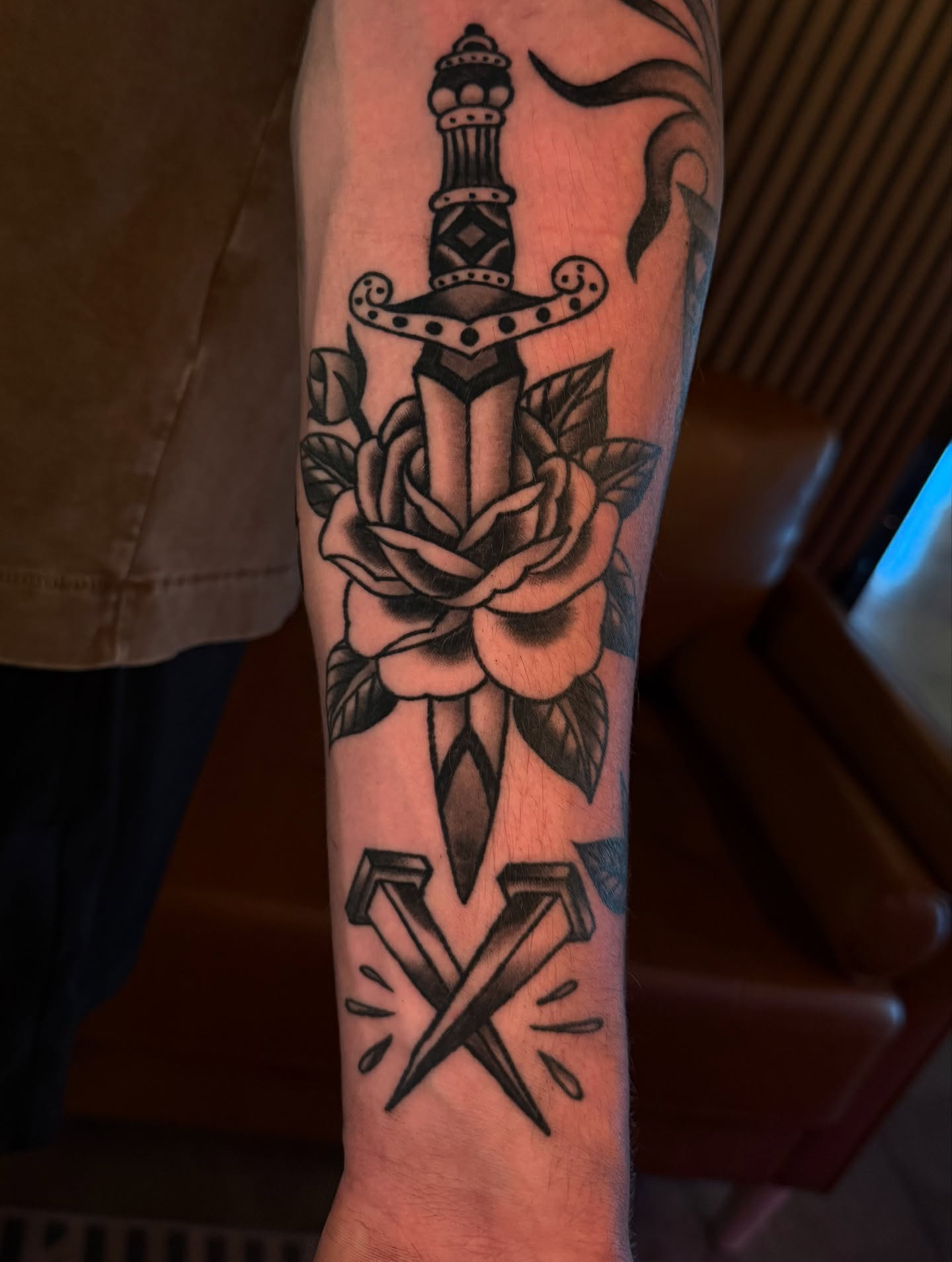 Sword, rose, anchor American traditional tattoo on the forearm by Cory Allen