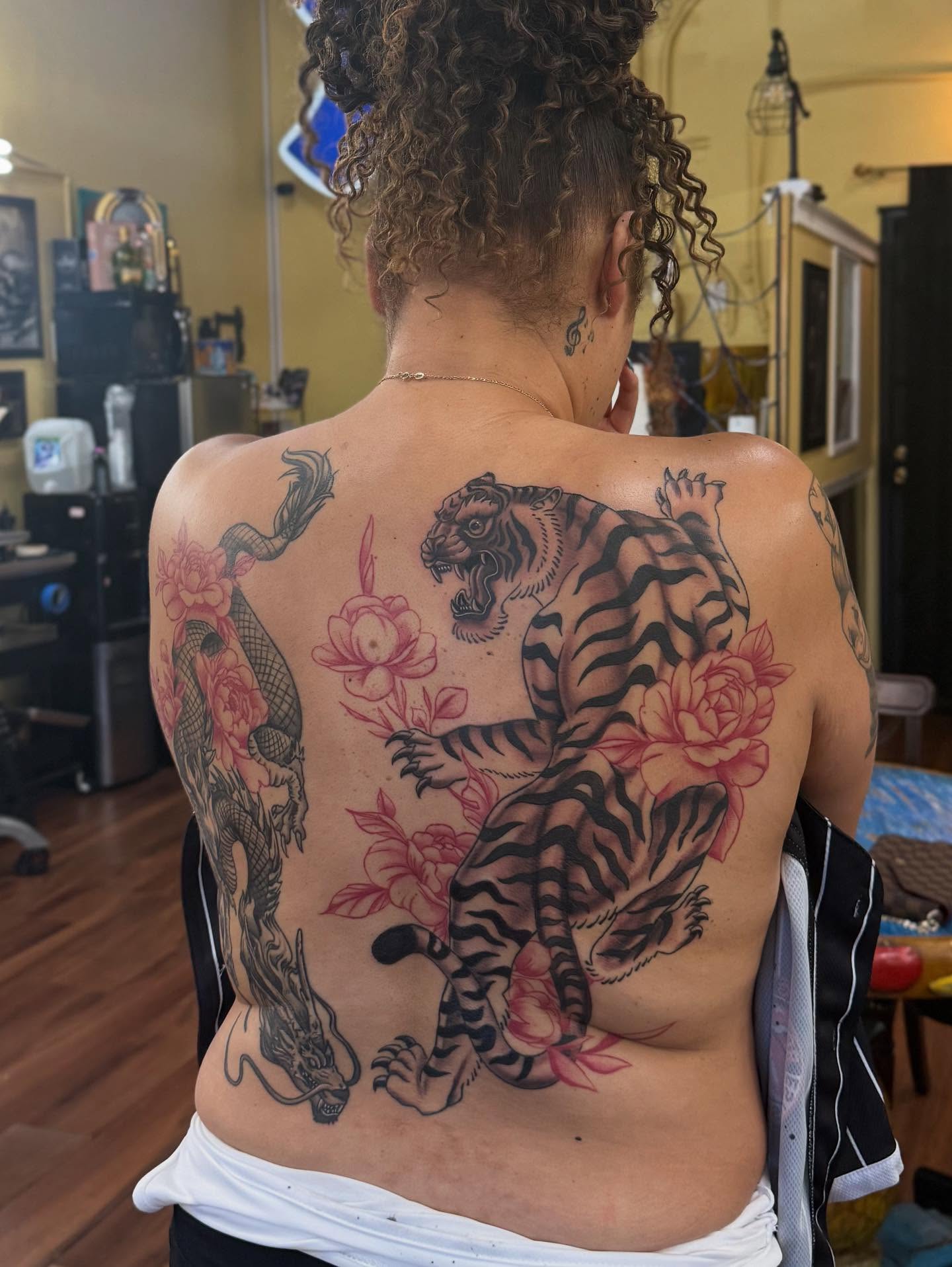Tiger and dragon American traditional tattoo on the back by Tanner Pastor