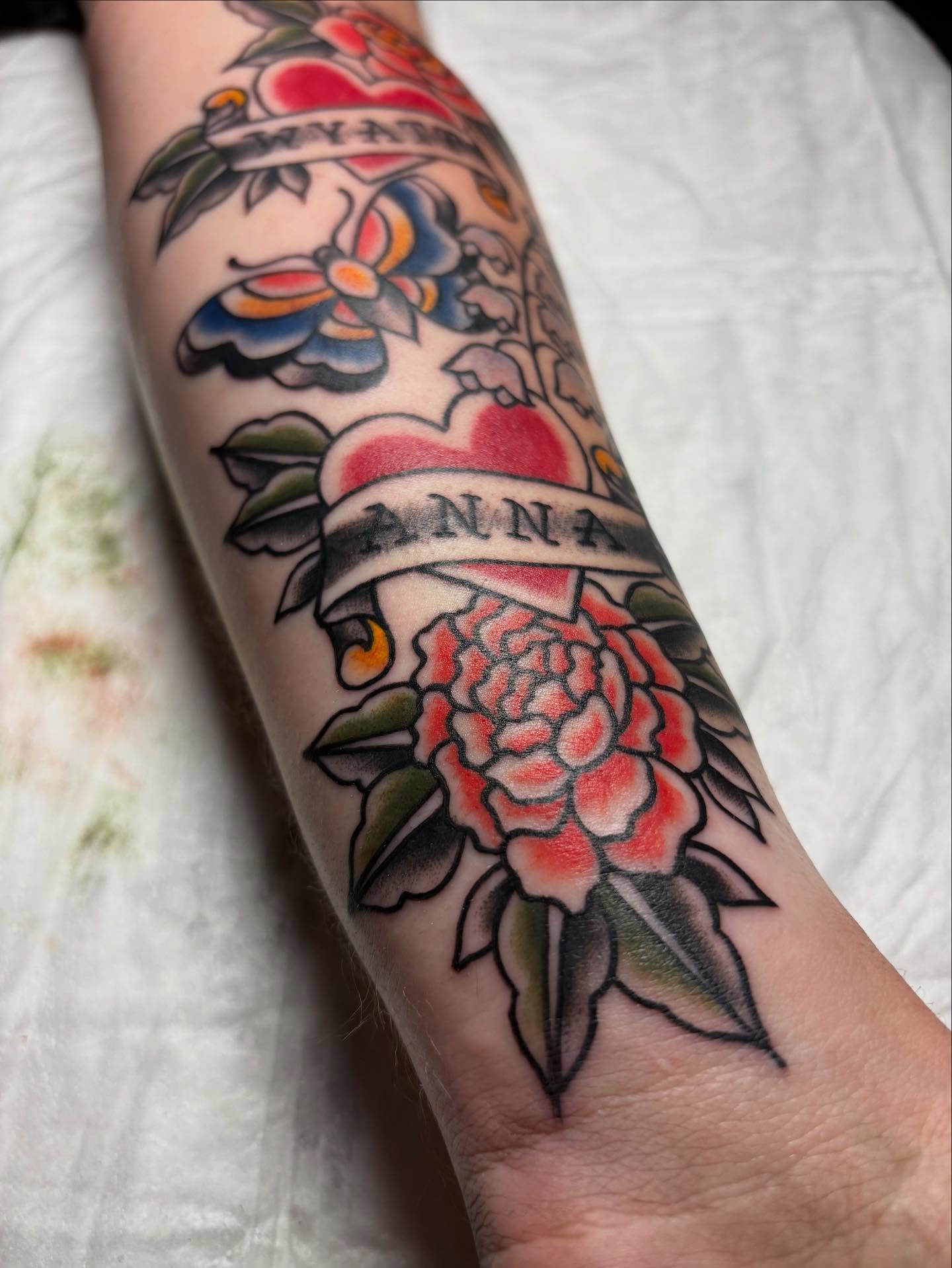 Peony and banner American traditional tattoo on the forearm by gia❤️‍🔥🎲, Maryville, Tennessee