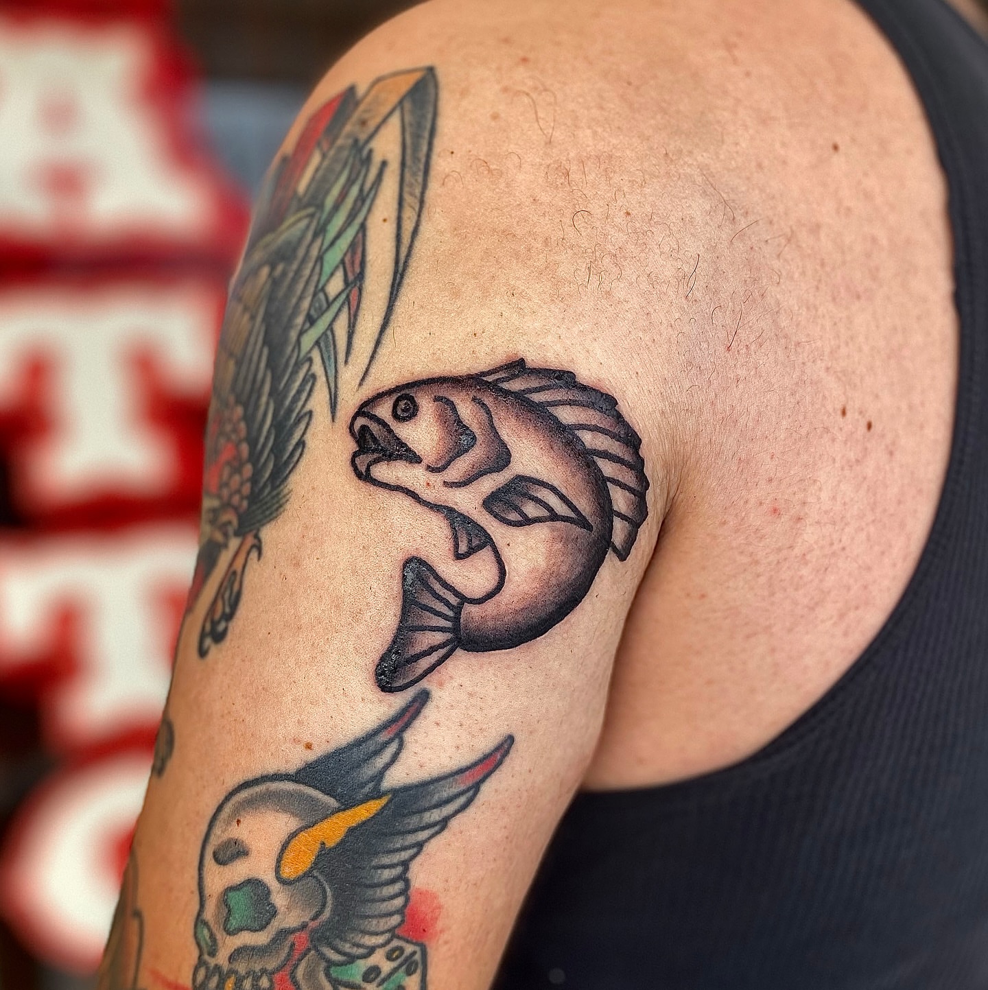 Fish American traditional tattoo on the shoulder by Myka King