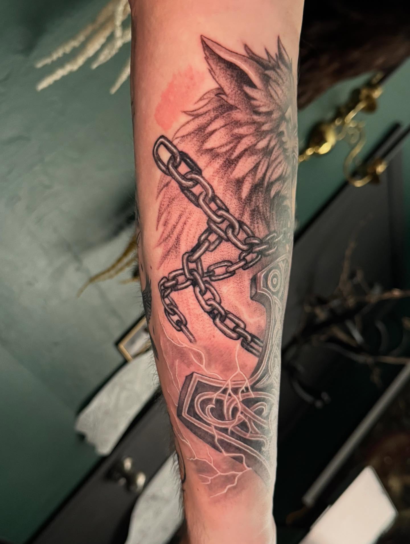Chains and bird realism tattoo on the forearm by Leslea Hipp