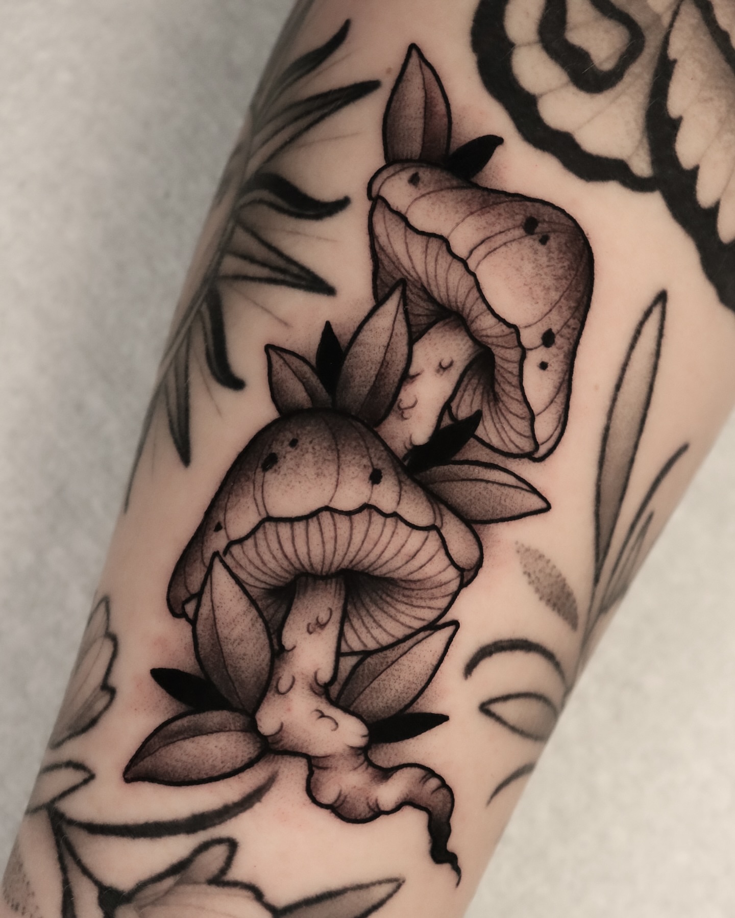 Mushrooms black and grey tattoo on the forearm by Jeff Reindel