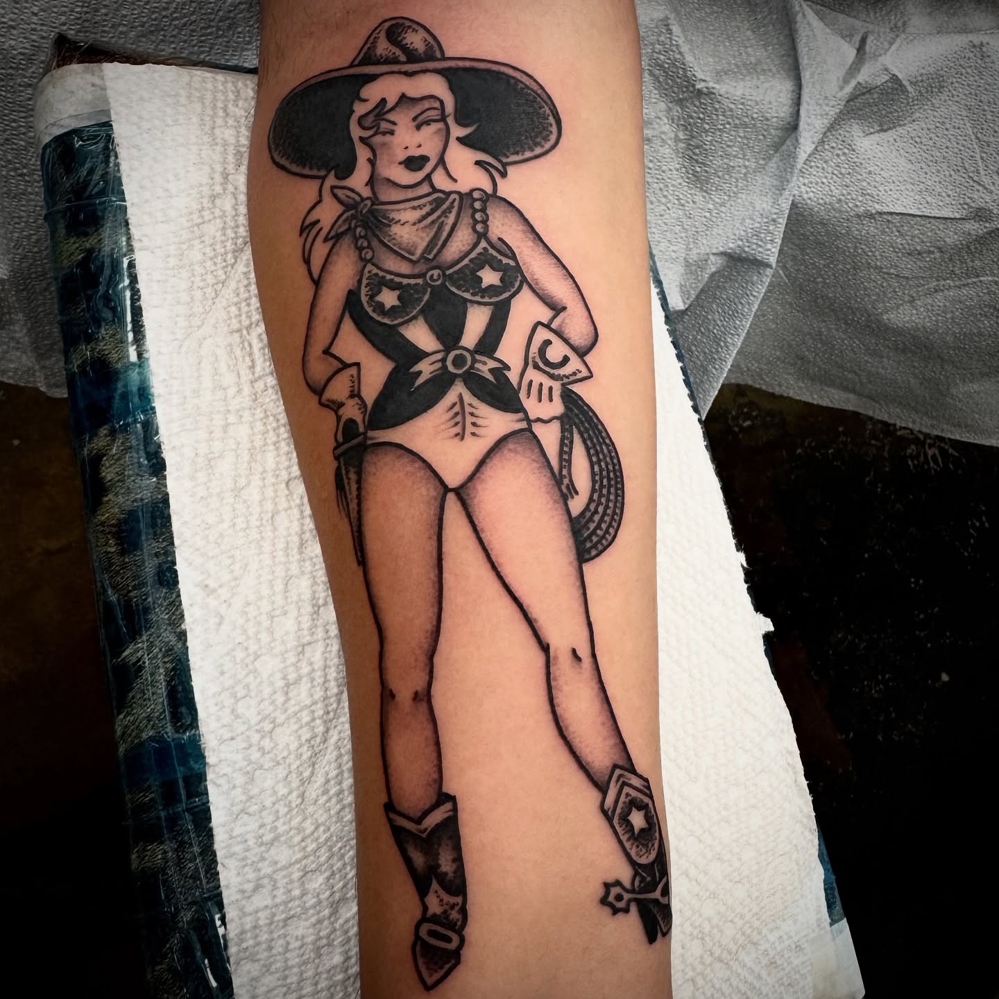 Cowgirl pin-up American traditional tattoo on the forearm by Kristen