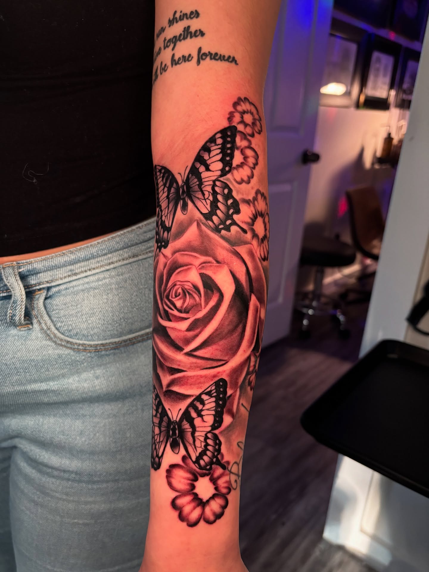 Rose and butterflies realism tattoo on the forearm by Eric Garcia