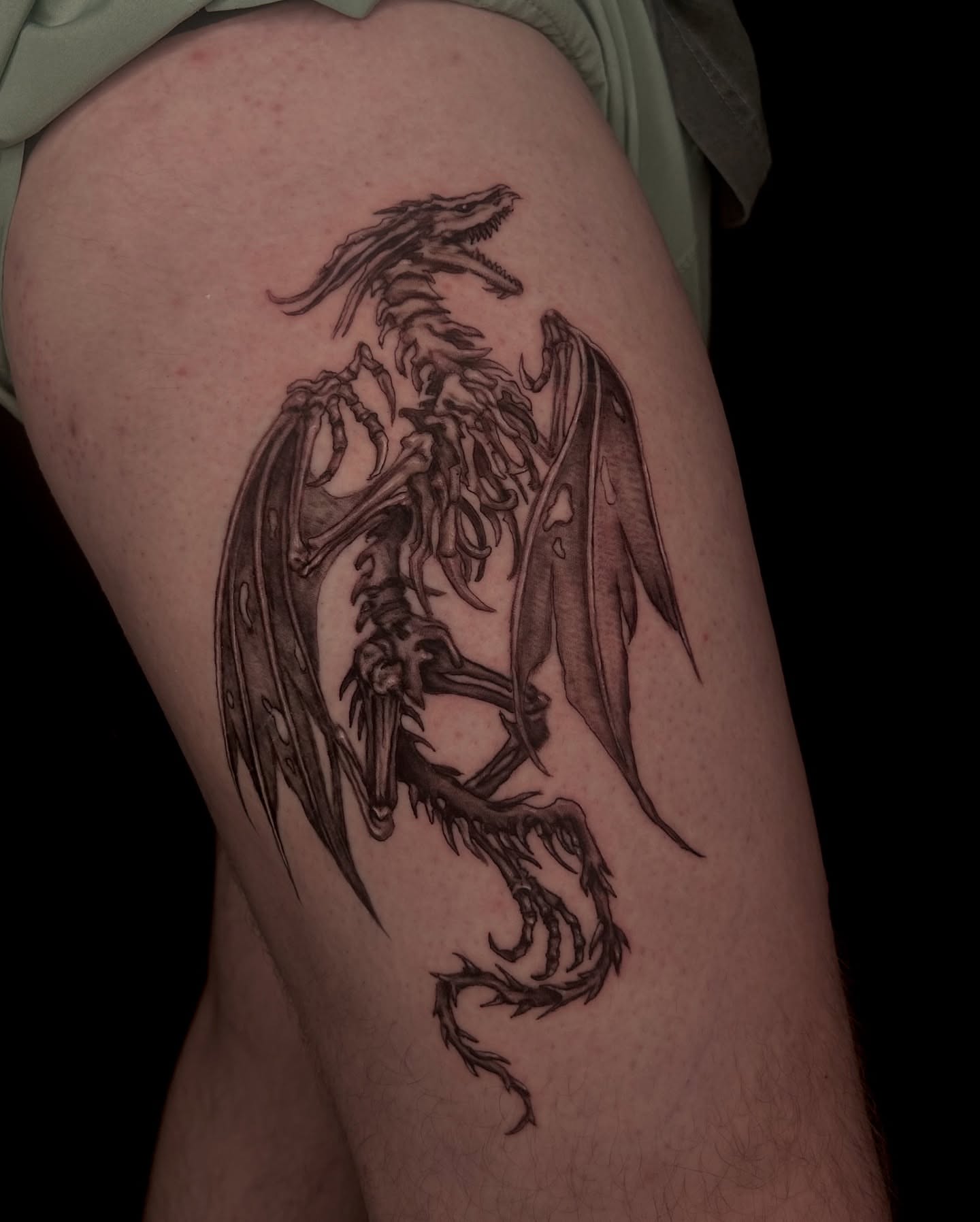 Dragon black and grey tattoo on the thigh by Haley
