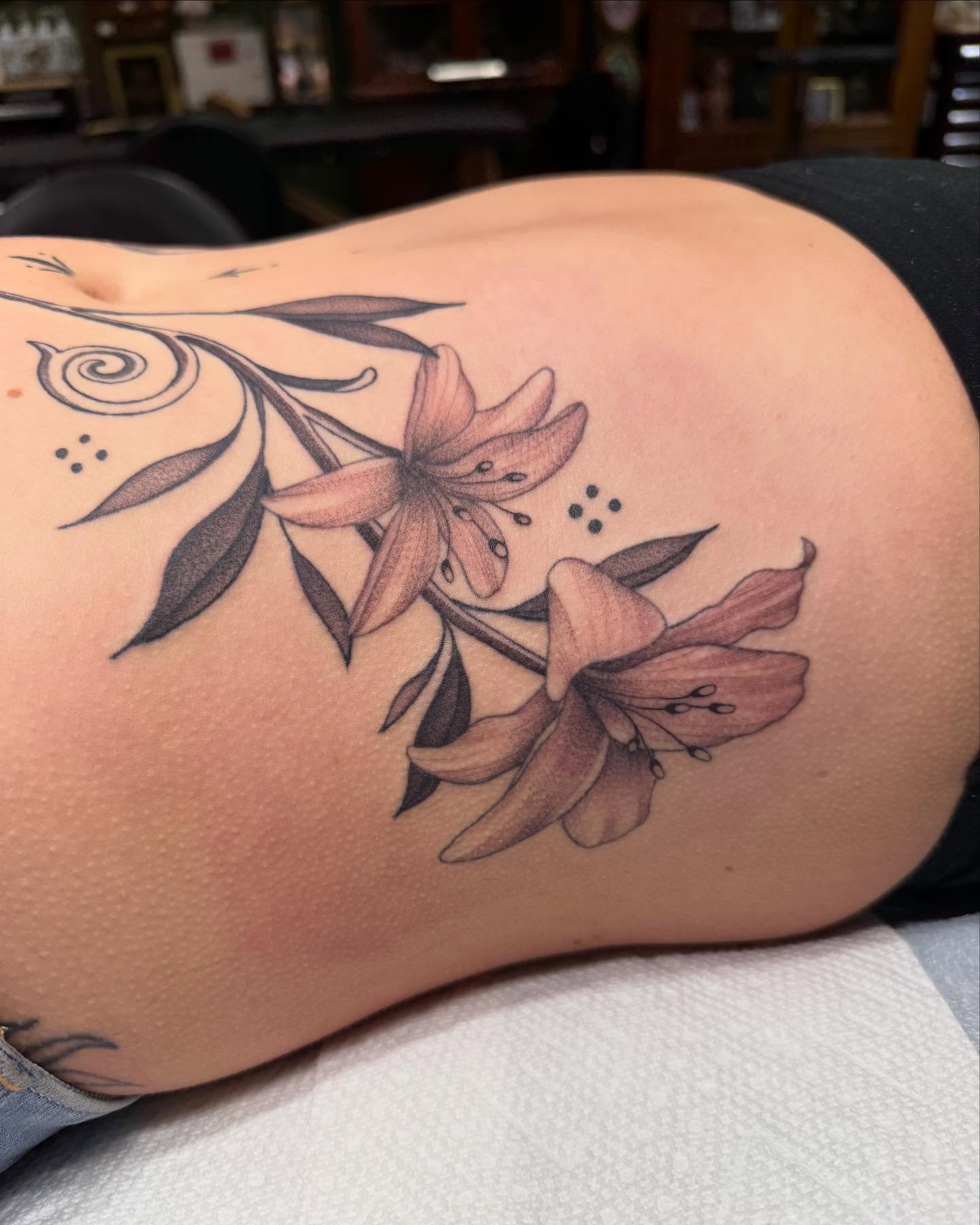 Lilies dotwork tattoo on the thigh by Maddie Jo DeYoung