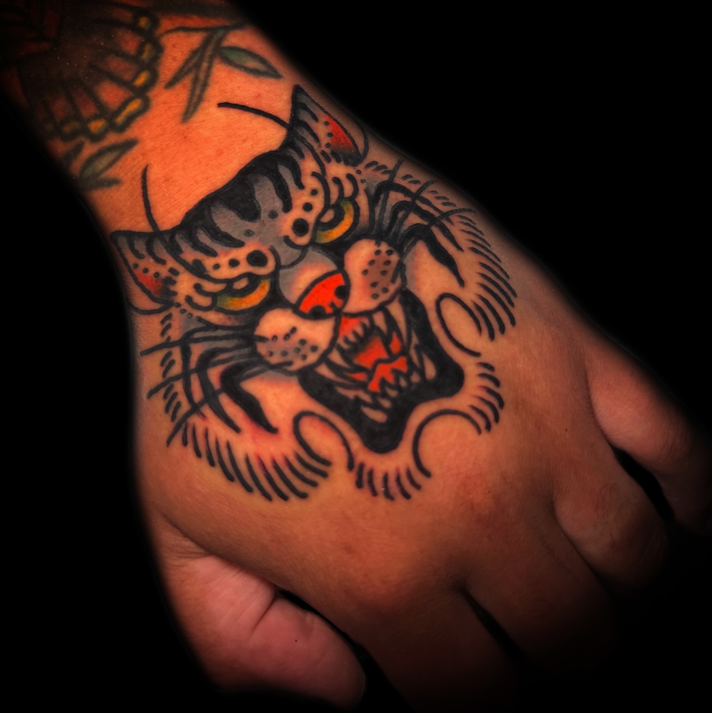 Tiger American traditional tattoo on the forearm by Danny Reis