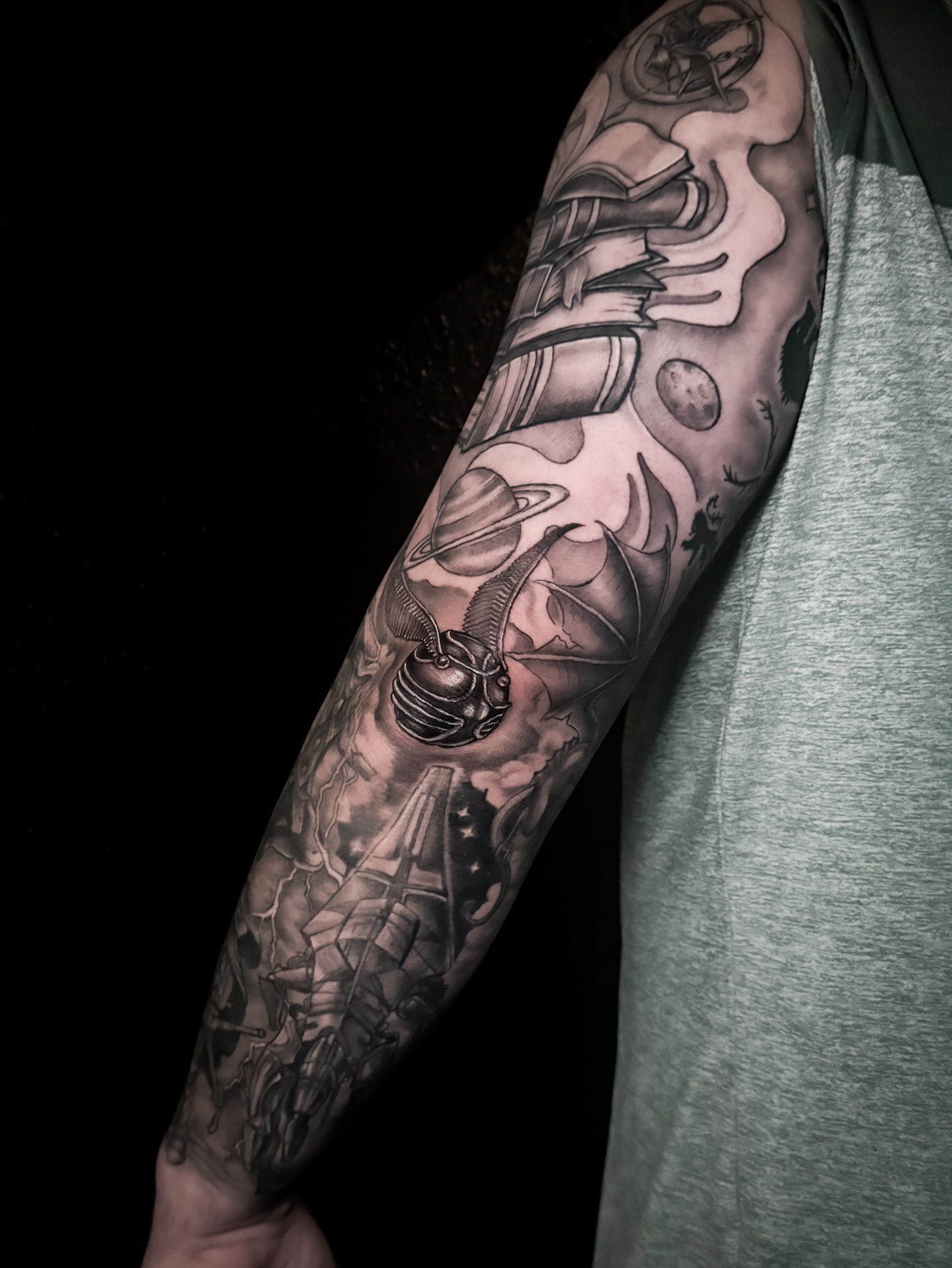 Space-themed elements realism tattoo on the forearm by Cristen Aro