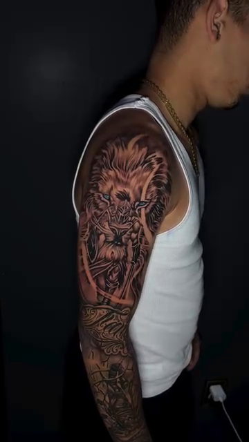 Lion head with floral elements realism tattoo by Paul burrows (Tatttoo Artist)