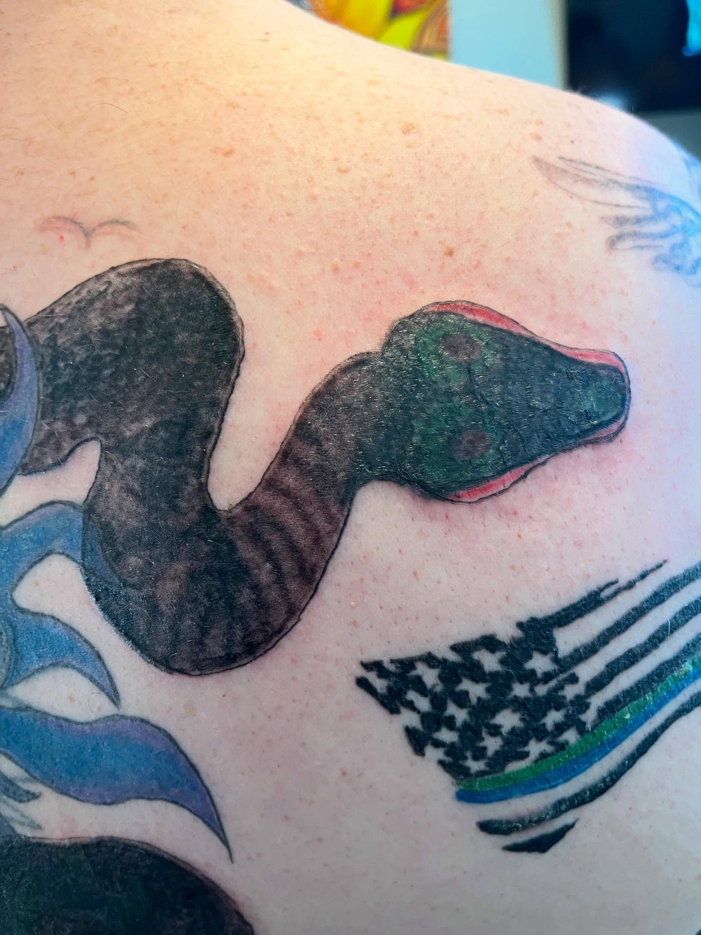 Snake American traditional tattoo on the shoulder by Val Maughan