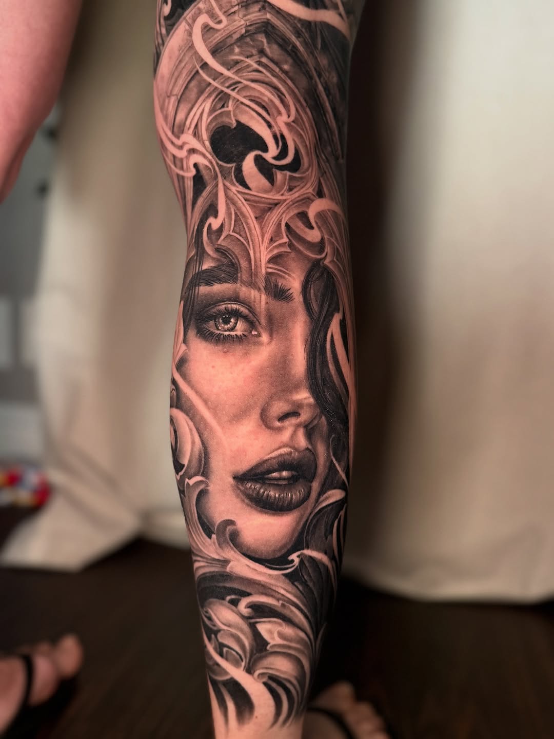 Woman's face with ornate details realism tattoo on the forearm by April Lynn