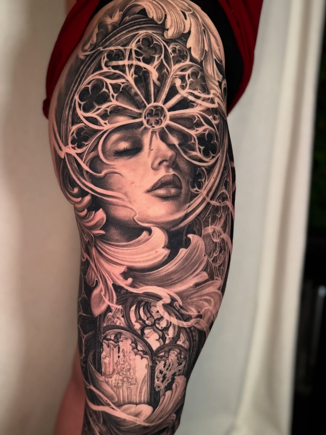 Woman's face with ornate window frame realism tattoo on the forearm by April Lynn