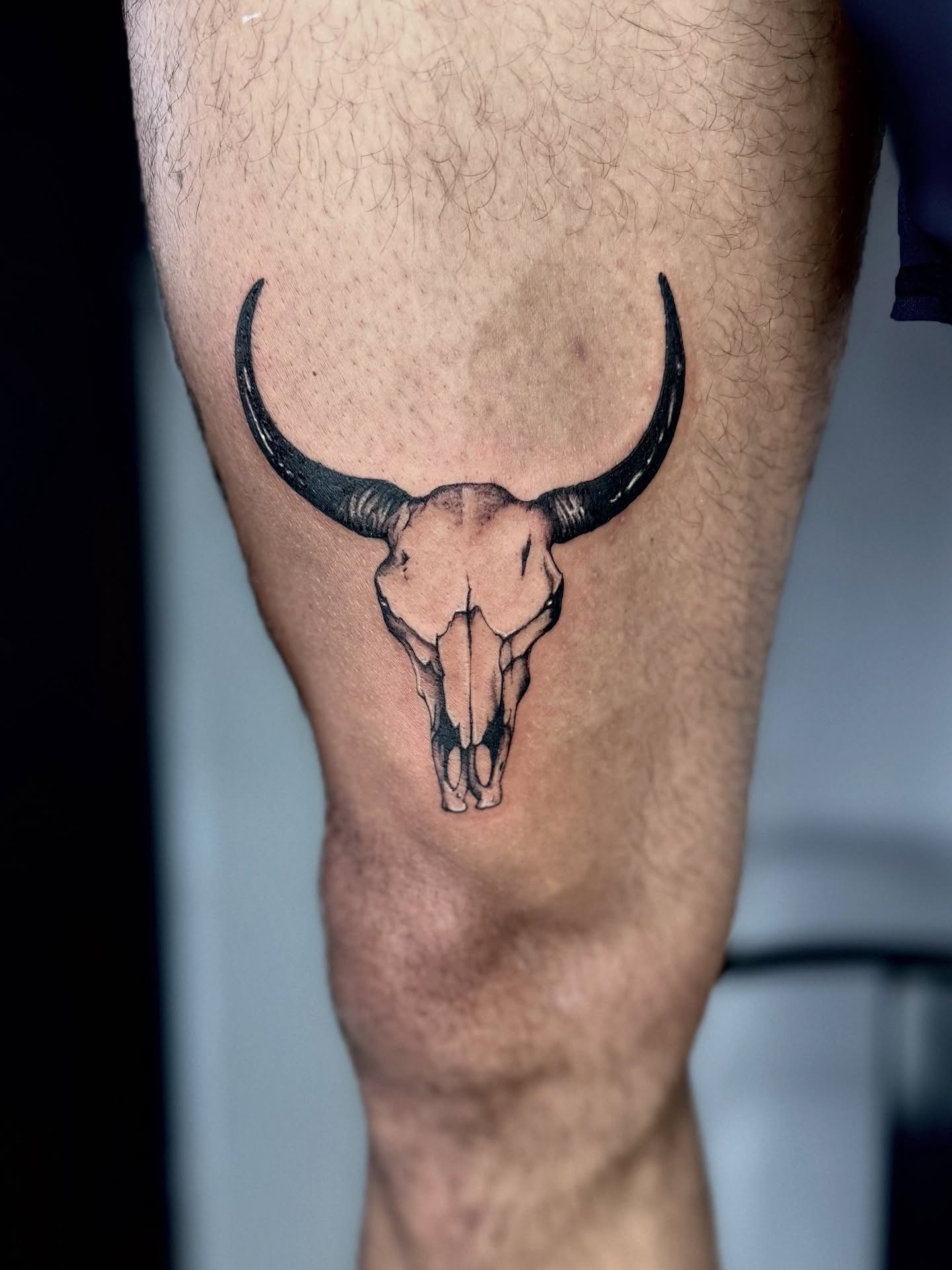 Bull skull black and grey tattoo on the thigh by Miro Ink Tattoo