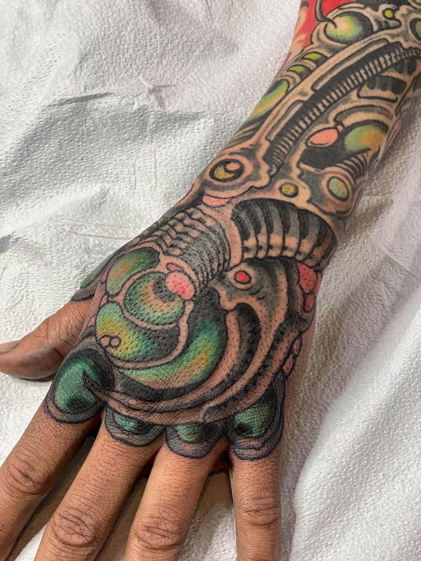 Mechanical biomech geometric tattoo on the hand by Zac Blevins