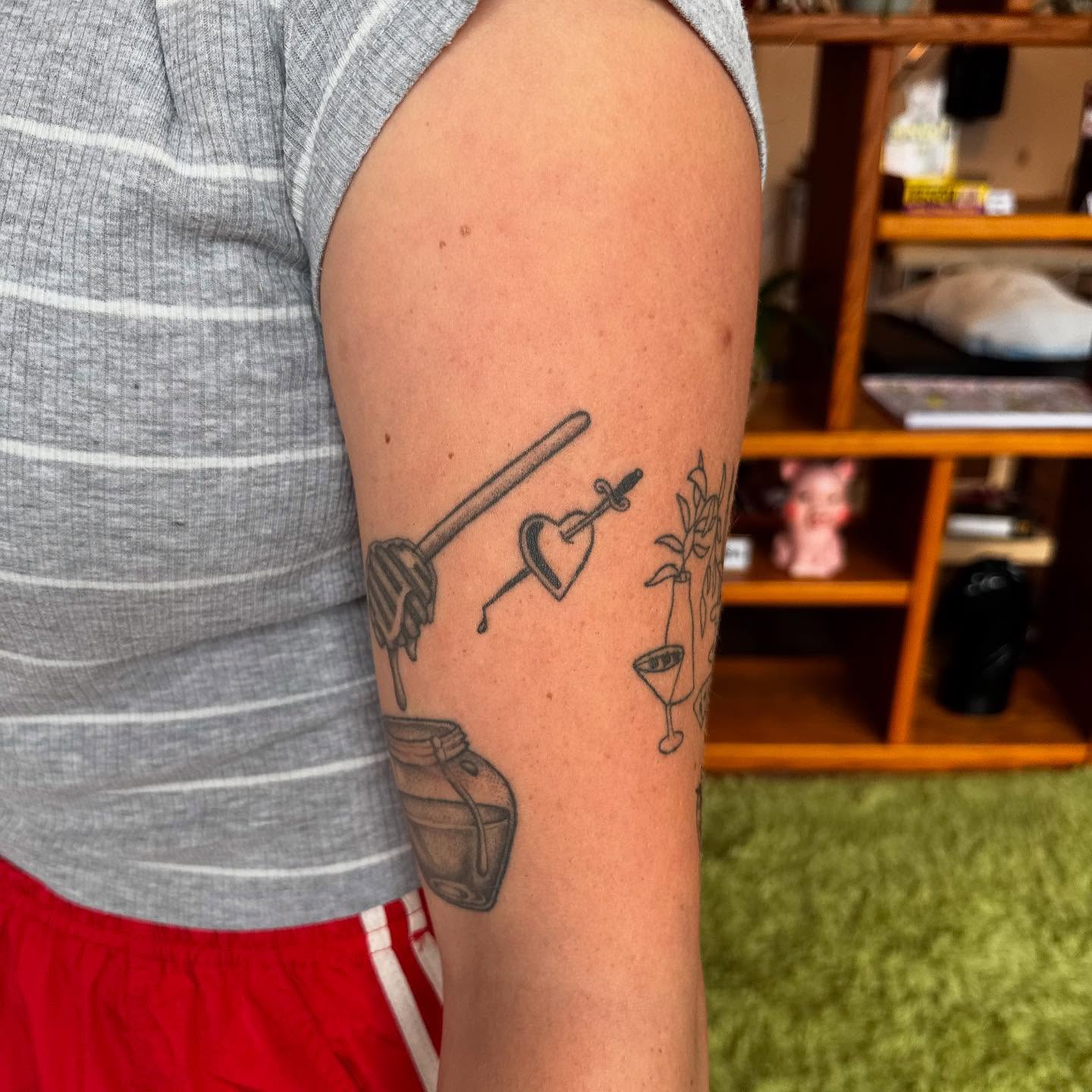 Honey dipper, heart, cocktail glass, plant black and grey tattoo on the forearm by house0fsleep 💤
