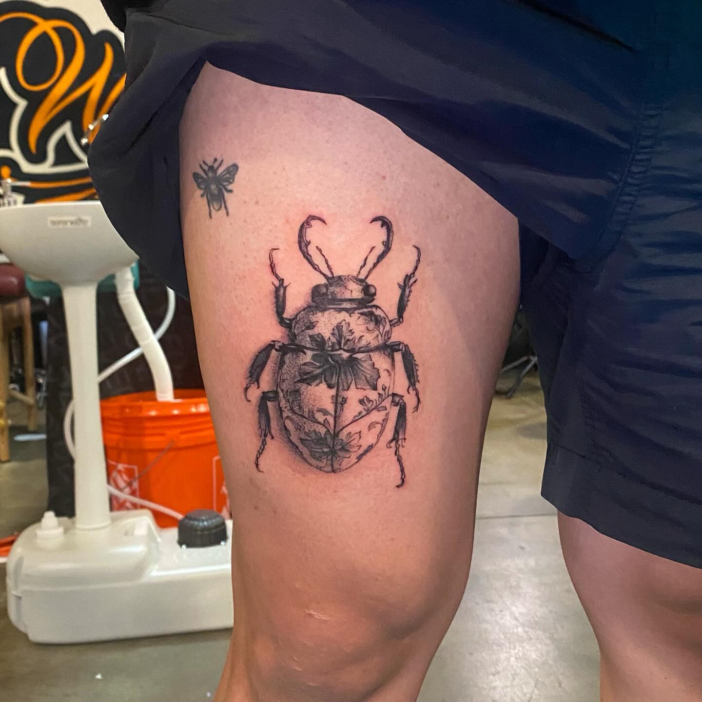 Beetle black and grey tattoo on the thigh by Prncjordn, Stallings, North Carolina