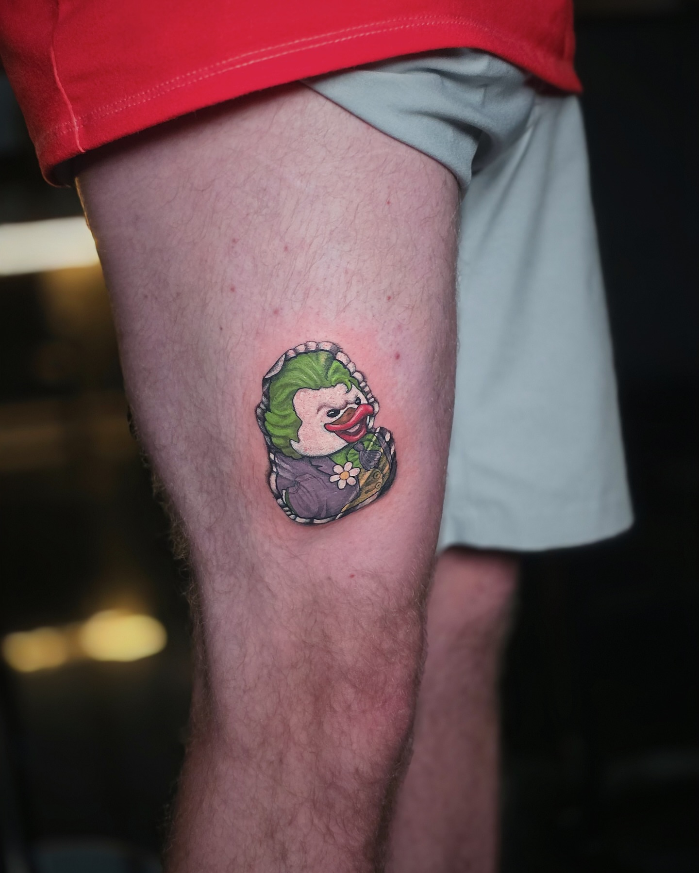 Clown duck illustrative tattoo on the thigh by Kelsey Zussman