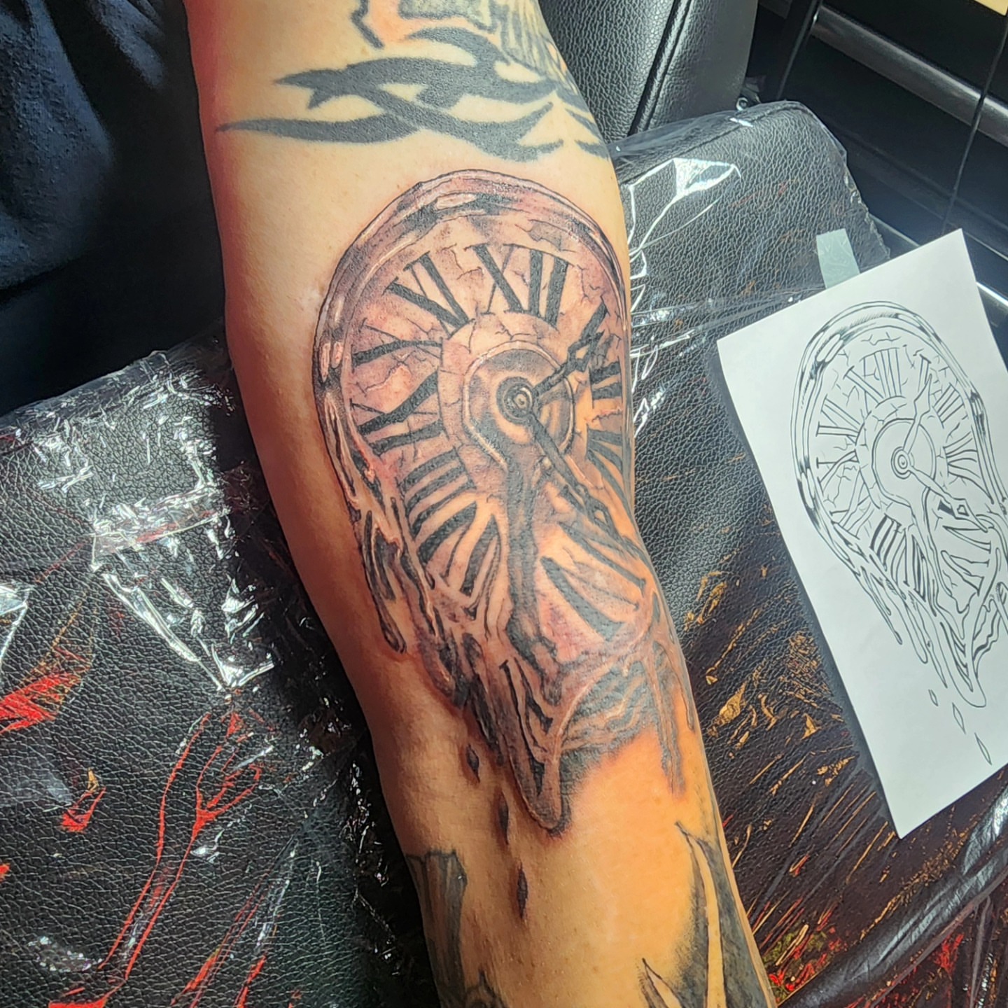 Clock black and grey tattoo on the forearm by Joe Garcia