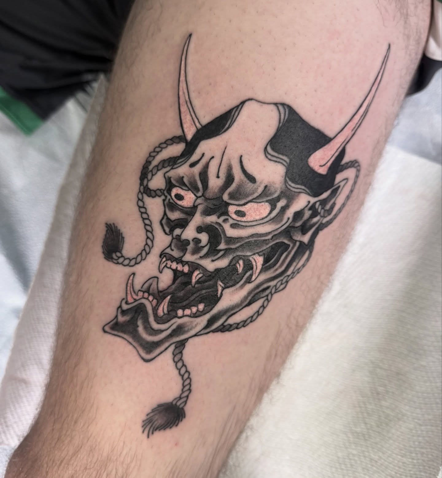 Demon mask black and grey tattoo on the forearm by Scott Kulikowski