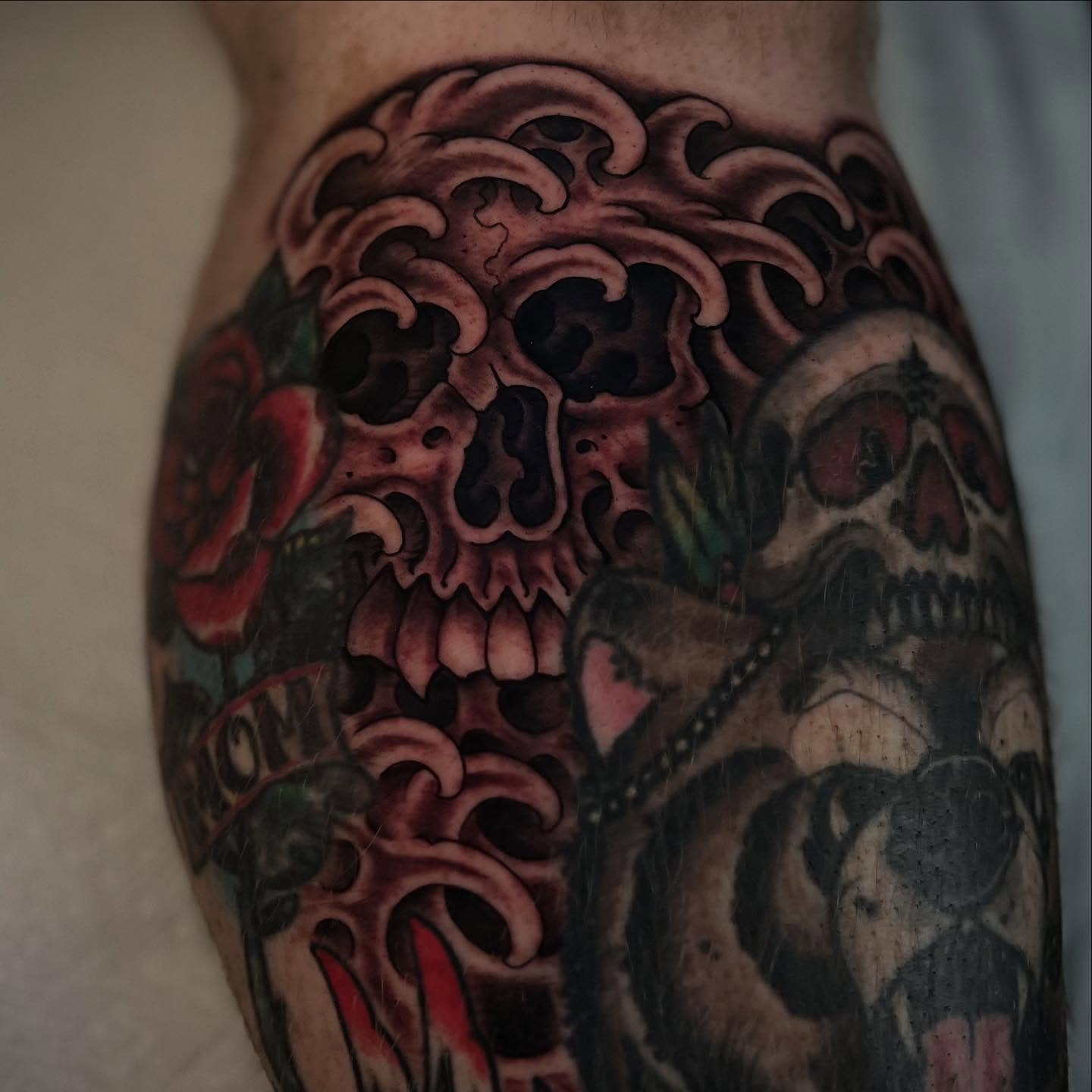 Skulls and roses American traditional tattoo on the forearm by Chris Romolini