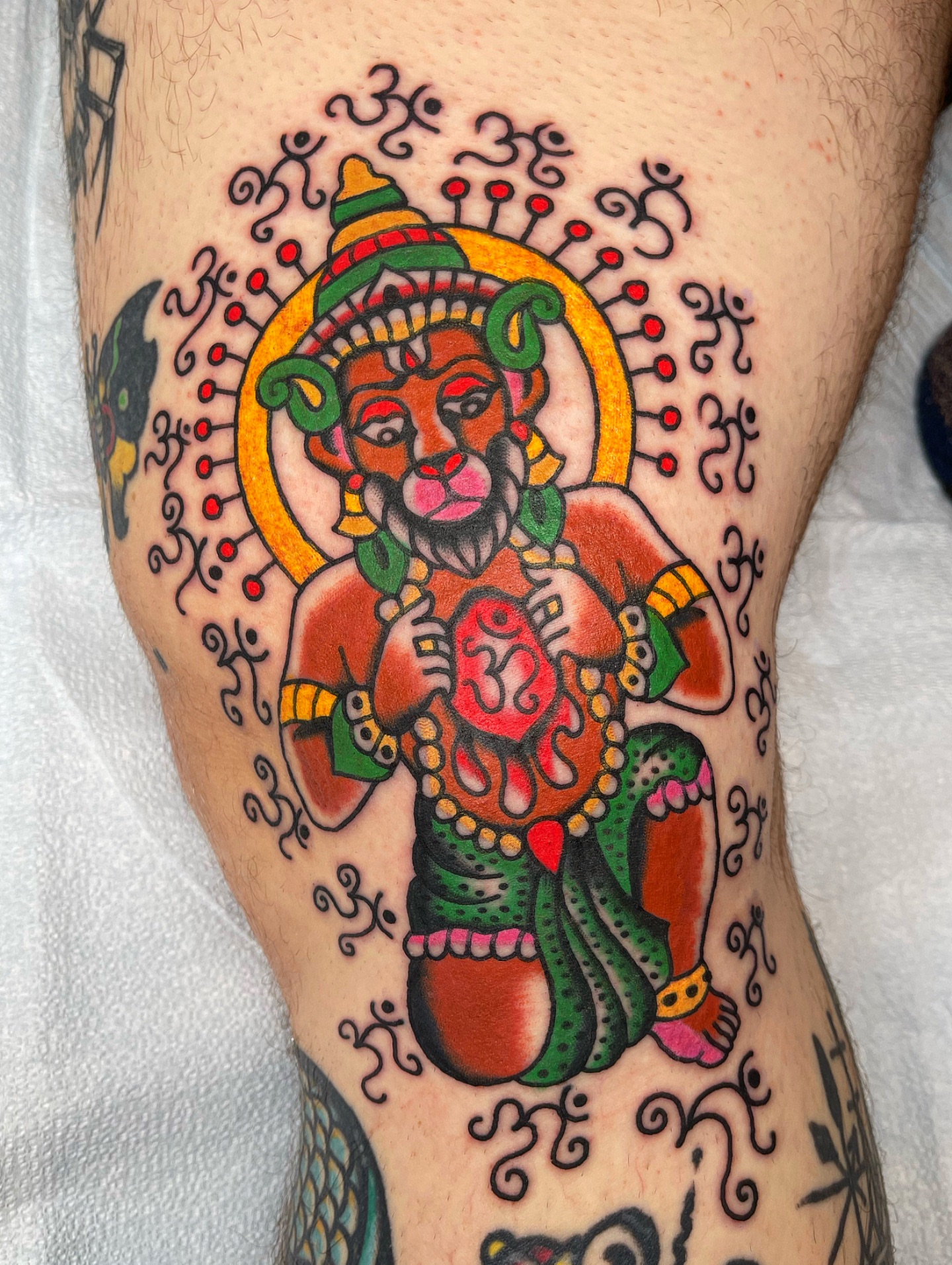 Lion deity American traditional tattoo on the thigh by Swasthik Iyengar, New York, New York
